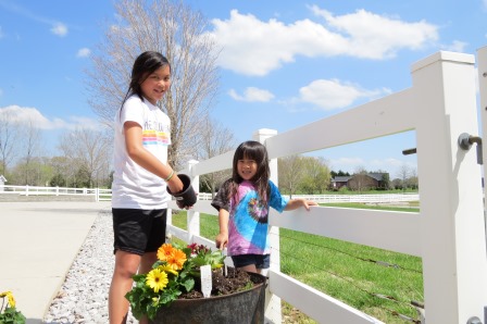 Kasen and Karis planting flowers